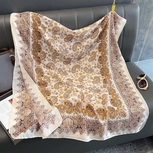Detail of vintage paisley print shawl on leather sofa with relaxed leisure vibe