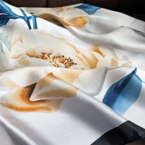 Elegant pearl white satin scarf with artistic yellow floral print and silky luster