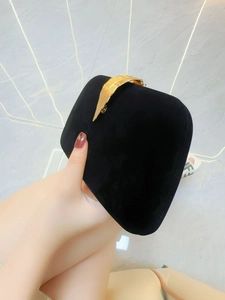 Elegant black velvet evening clutch with gold leaf-shaped metal handle and square design