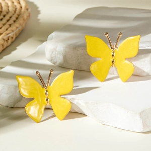 Boucles d'oreilles papillon en émail jaune avec bords dorés sur socle en marbre