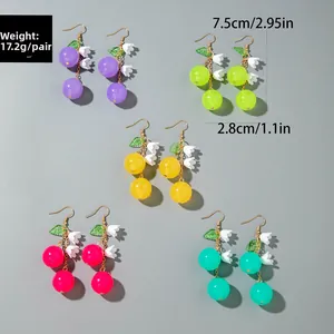 Macro detail of colorful berry earrings in purple, green, yellow, rose and blue resin