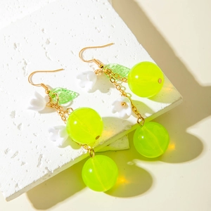 Detailed shot of cherry drop earrings with green translucent beads and lily petals