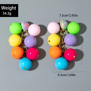 Detail of colorful acrylic cherry earrings with multi-color beads and gold-tone chain links