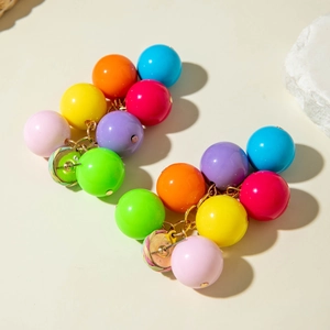 Detail of colorful acrylic cherry bead drop earrings with vibrant multi-colored resin spheres