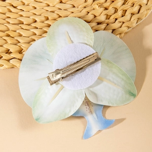 Detailed back view of tropical orchid hair clip with secure silver metal alligator fastener