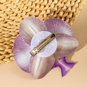 Detailed back view of purple orchid hair clip with metal alligator grip and felt base