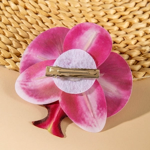 Detail view showing back of pink orchid hair clip with metal alligator grip and felt base