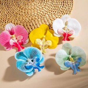 Vibrant Phalaenopsis orchid hair clips in five colors for a tropical beach style look