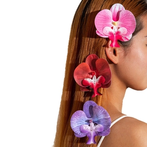 Realistic orchid flower hair clips in gradient colors on a female model for summer style