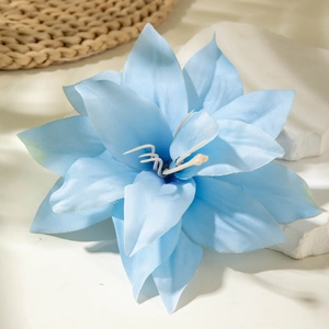 Close-up of sky blue faux lily fabric hair clip with soft layered petals and creamy center