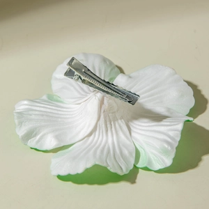 Detail view of the silver metal duckbill clip and textured white lily petal finish