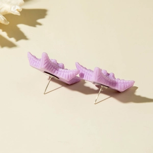 Detail view of light purple resin starfish earrings with textured beach style finish