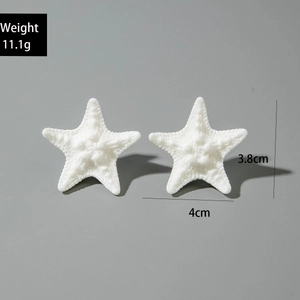 Detail showing white resin starfish earrings with dimensions 4cm x 3.8cm and 11.1g weight