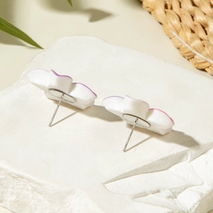 Detailed back view of white resin daisy earrings with pink gradient on stone base