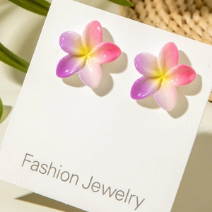 Detail of tropical plumeria flower earrings with pink and purple gradient petals