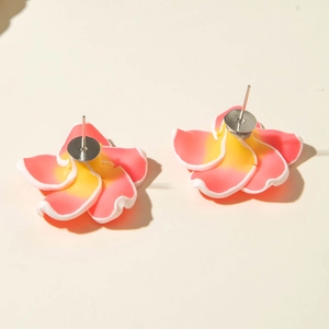 Macro view of daisy resin flower earrings with pink and yellow gradient petals