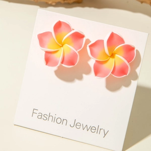 Detailed close-up of pink plumeria flower stud earrings with gradient yellow center