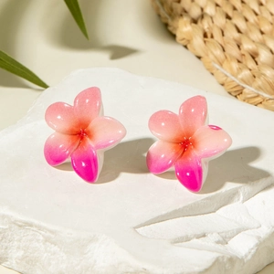 Pink daisy resin floral stud earrings on white stone with summer vacation vibes