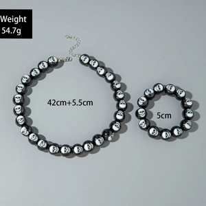 Detail of black skull pattern bead necklace and bracelet set with silver lobster clasp