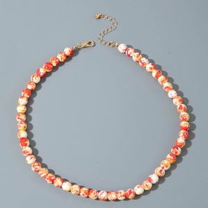Macro detail of multi-colored marble beads on a festive Halloween necklace set