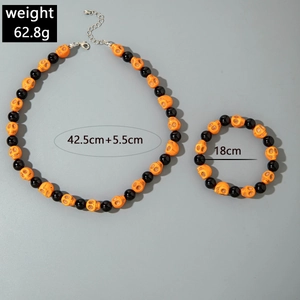 Detailed view of Halloween set with orange skull beads and size measurement labels