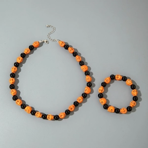 Detail of Halloween jewelry set with orange skull beads and black round beads