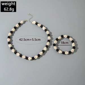 Detail view of skull beads necklace and bracelet set with dimensions and weight info