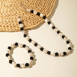 Detail of gothic skeleton skull necklace and bracelet set with black beads for Halloween