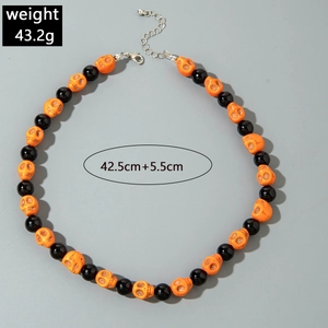 Detail of Halloween skull necklace showing orange beads, black pearls and lobster clasp