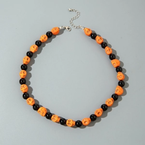 Close-up of Halloween necklace with orange skull beads and adjustable silver clasp