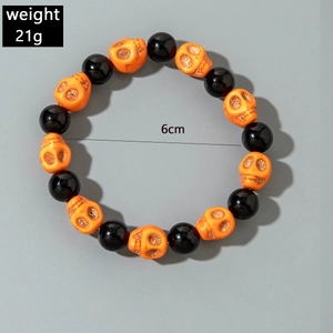 Detail view of Halloween stretch bracelet with orange skull beads and black round beads