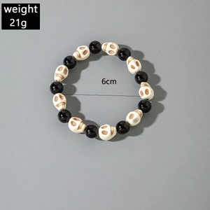 Gothic beaded bracelet detail with black shiny beads, skull charms, 6cm diameter and 21g weight