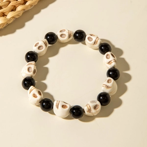 Detailed view of Halloween beaded bracelet featuring black beads and vintage skull charms
