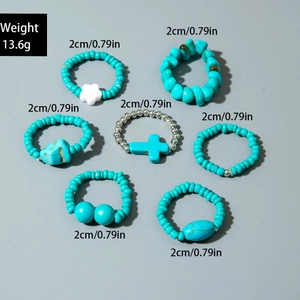 Detail shot of 7-piece turquoise and pearl ring set showing size and weight specs