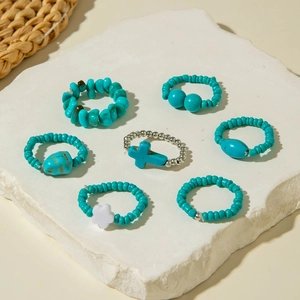 Detailed view of bohemian 7-piece turquoise and pearl beaded stretch rings set
