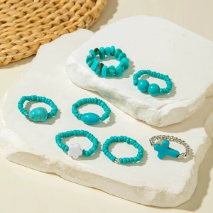 Detail view of 7-piece bohemian ring set with turquoise beads and silver cross charms