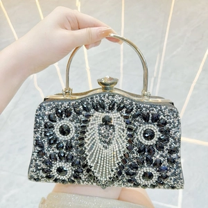 Detailed macro of a luxury evening bag featuring intricate crystal patterns and metal handle