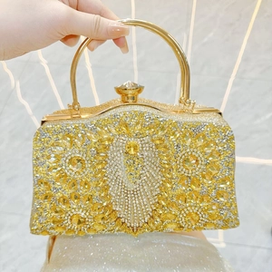 Close-up of golden evening clutch with radiant crystal patterns and diamond clasp