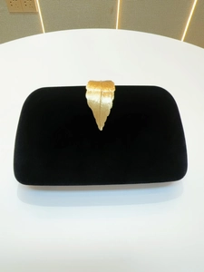 Elegant black velvet evening clutch bag with luxury gold leaf-shaped metal clasp