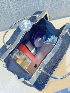 Deep blue sparkly evening clutch bag showing spacious interior with luxury diamond clasp