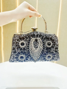 Detail of luxury evening bag with symmetrical black and white crystal peacock pattern