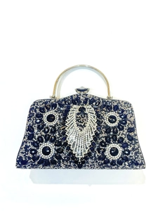 Close-up of luxury navy blue evening clutch featuring intricate crystal feather pattern