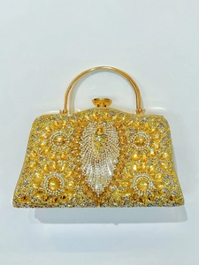 Detail showing radiant yellow rhinestone pattern and golden circular metal handle