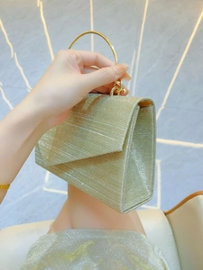 Elegant gold glitter evening bag with round metal ring handle and textured hard case finish