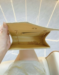 Interior view of gold sequin evening bag featuring card slot and magnetic metal clasp