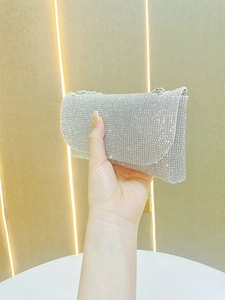 Elegant silver rhinestone clutch bag with metallic chain strap for evening parties