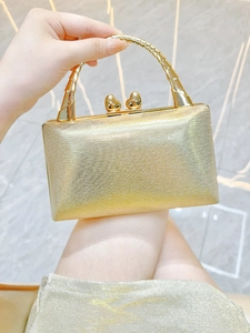 Elegant gold rectangular evening clutch bag with sparkling finish and heart-shaped metal clasp