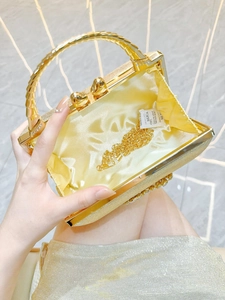 Interior view of gold glitter evening clutch bag with heart clasp and chain strap