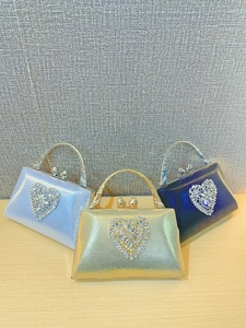 Elegant heart-shaped evening bags in silver, gold, and navy with sparkling rhinestones