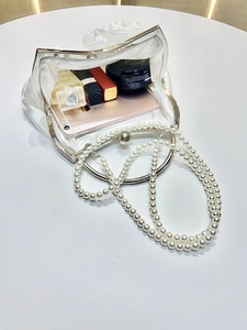 White satin floral evening clutch bag with pearl strap and metal handle in open view